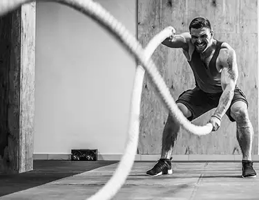 A man is training with crossfit ropes